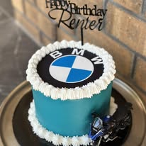 Teal BMW birthday cake with white shell piping, BMW logo and motorbike topper for Renter